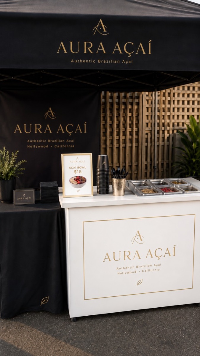 Complete Aura Açaí branded catering setup with canopy, service counter, toppings, cups, and event signage